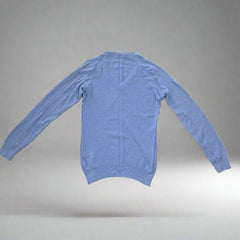 Blue long-sleeve shirt on a tiled floor