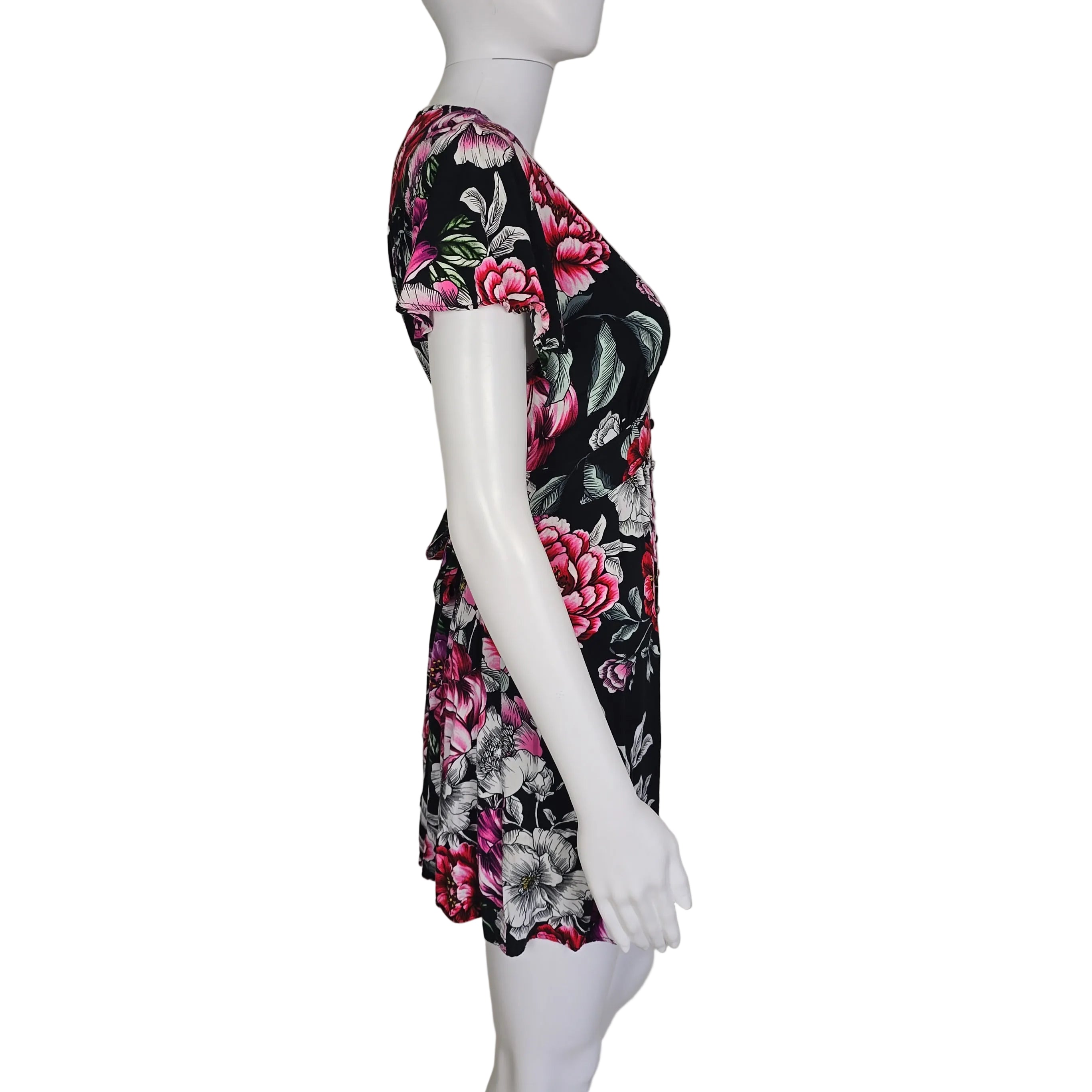 Floral-patterned dress on a mannequin against a plain background