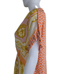 Fabric with orange and pink pattern on a mannequin against a plain background