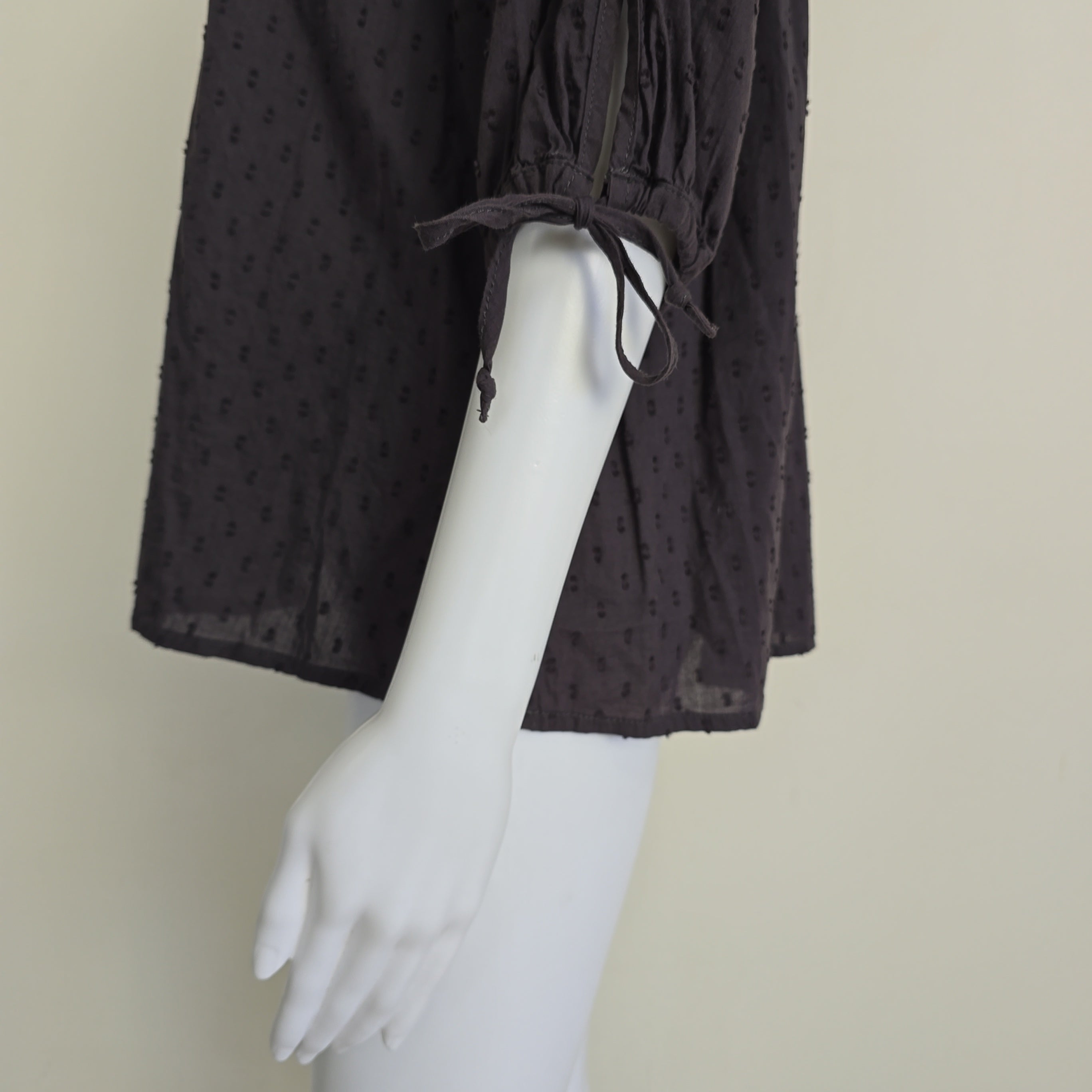 Brown long-sleeve top on a light background