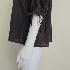 Brown long-sleeve top on a light background