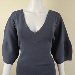 Gray dress on a mannequin against a beige background