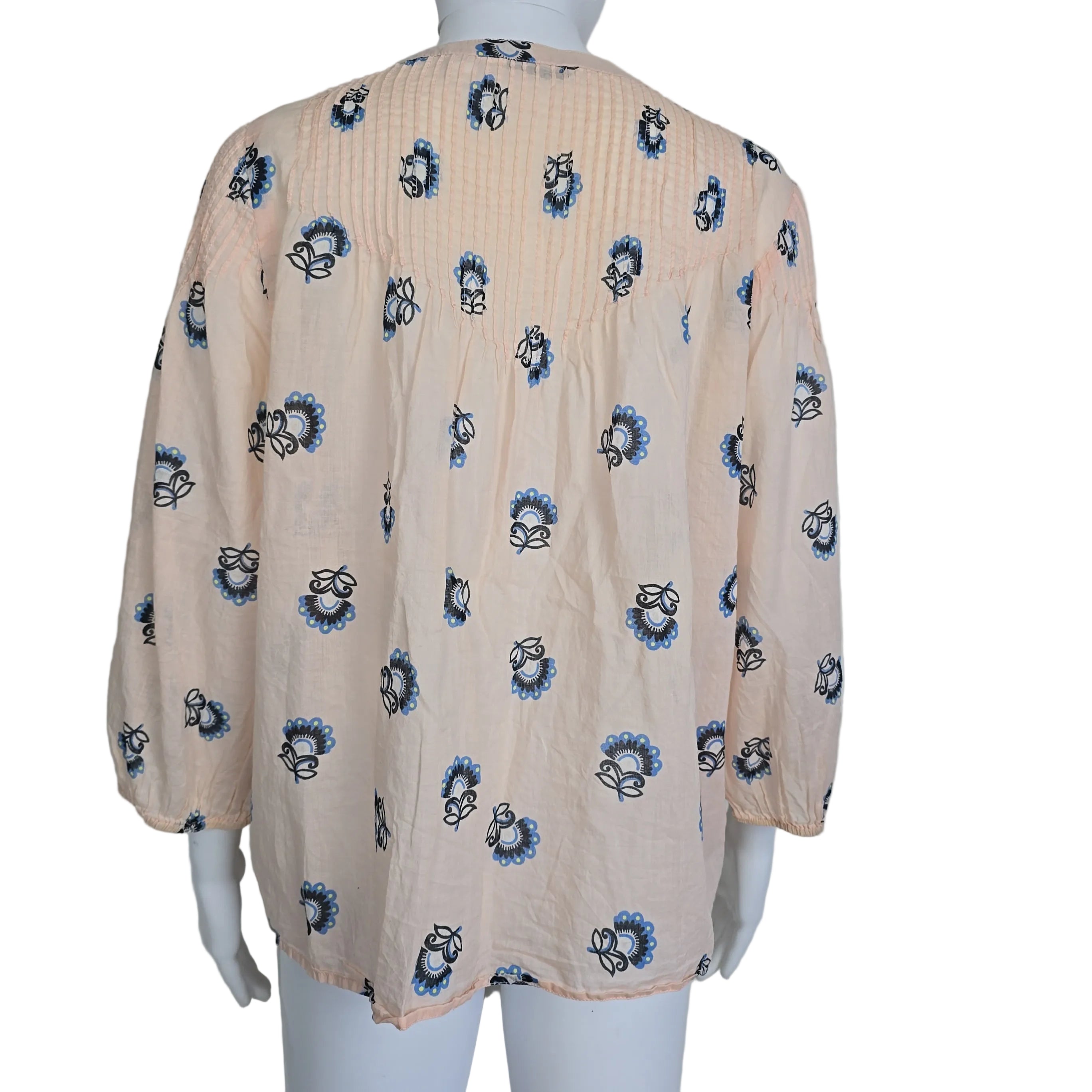 Floral-patterned flowy top on a light background