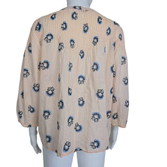 Floral-patterned flowy top on a light background