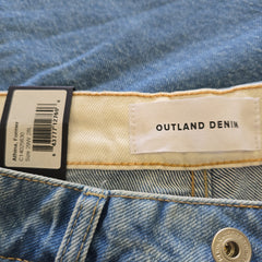 Close-up of Outland Denim label on denim jeans
