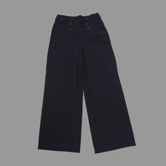 Black pants on a tiled floor