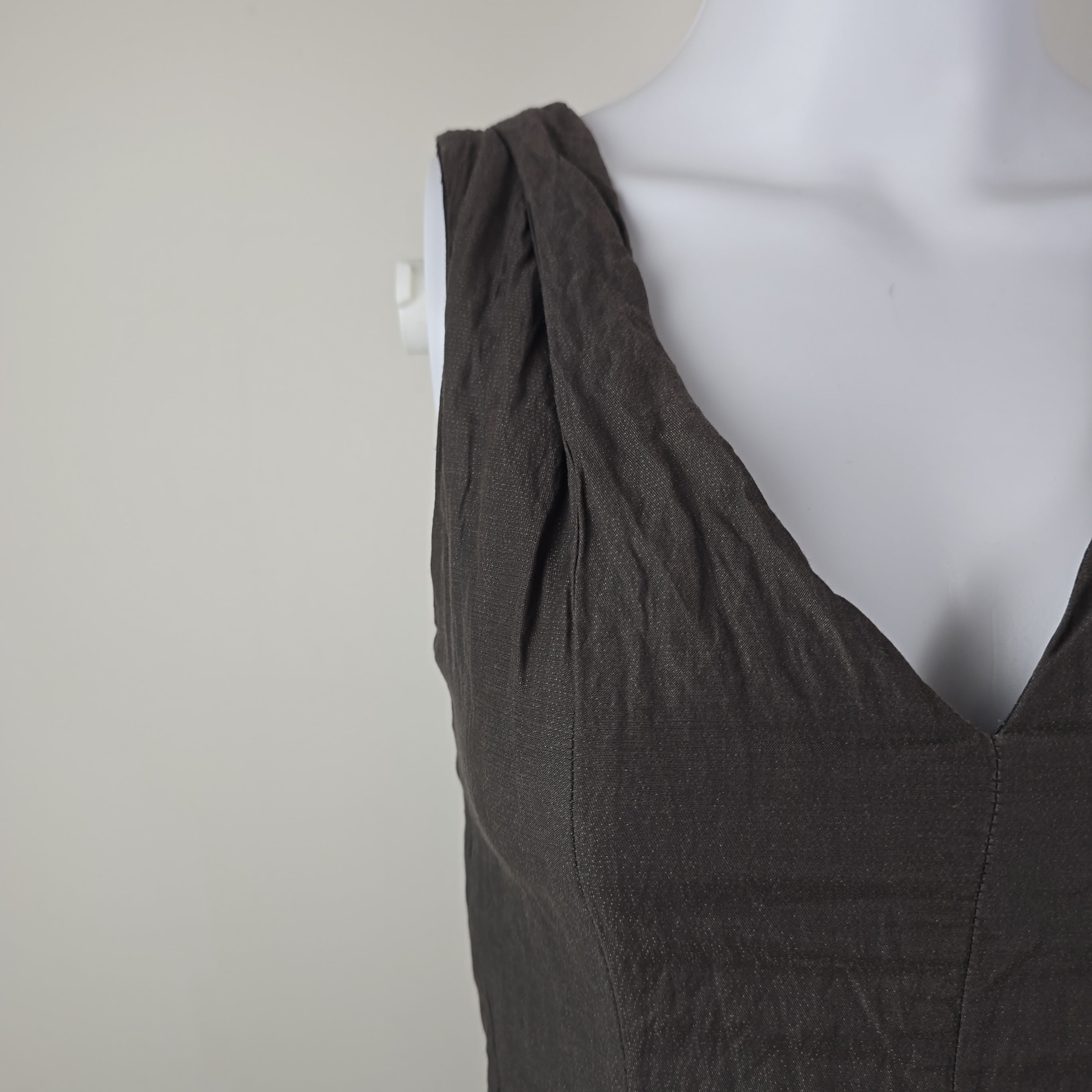 Dark gray dress on a mannequin against a white background