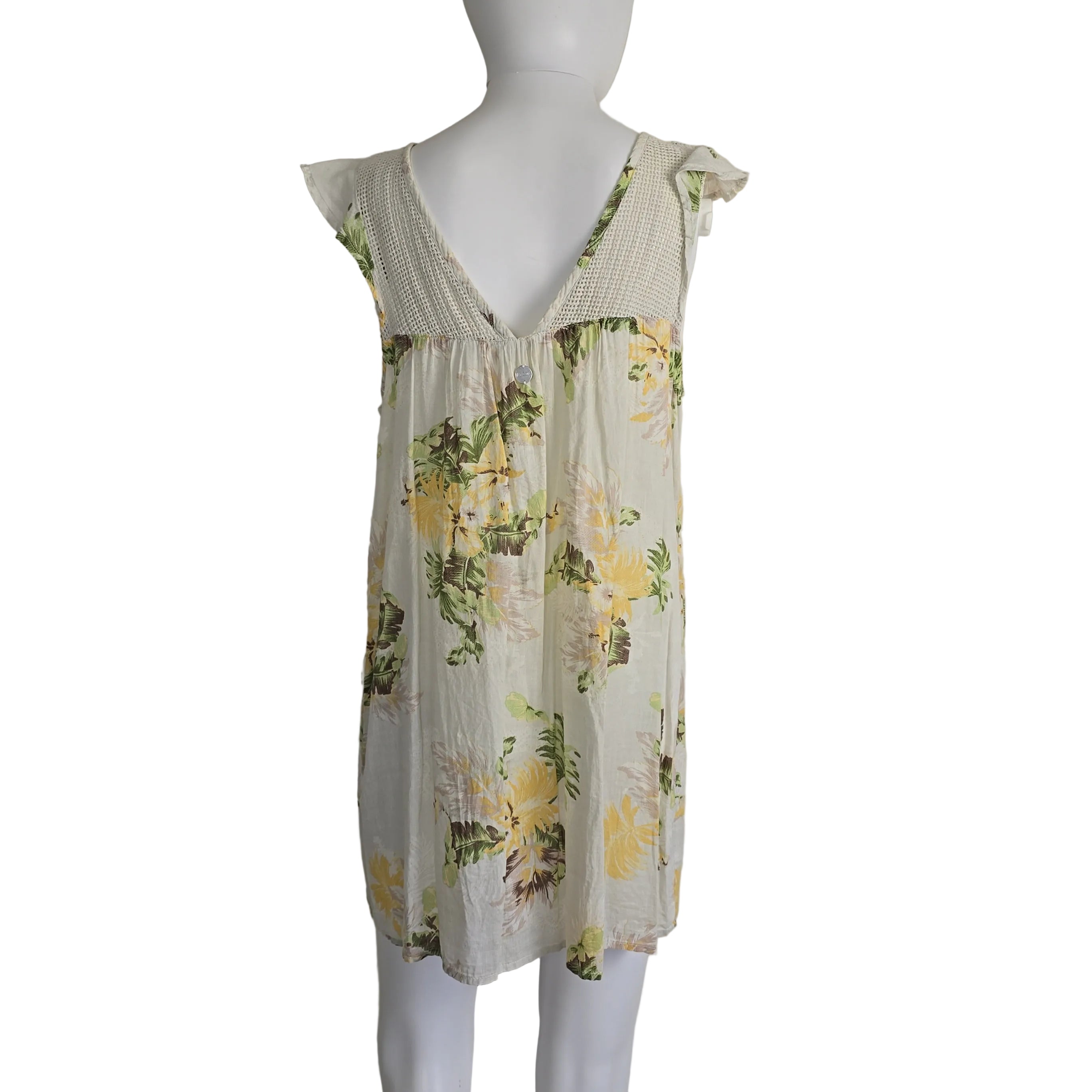 Floral dress on a mannequin against a plain background