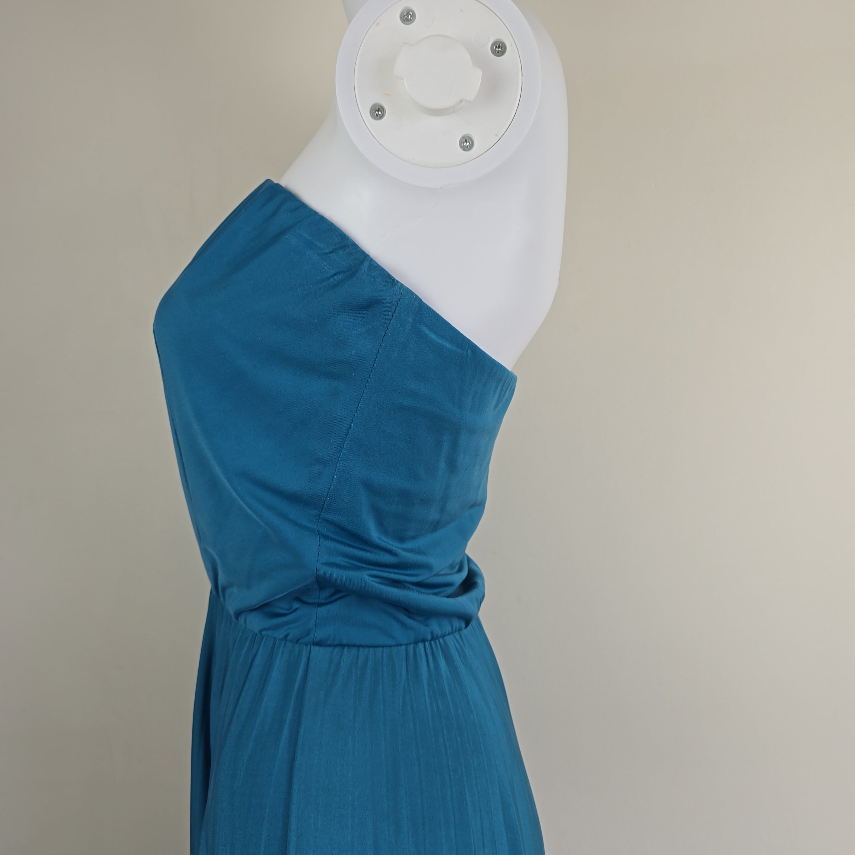 Blue dress on a mannequin against a neutral background