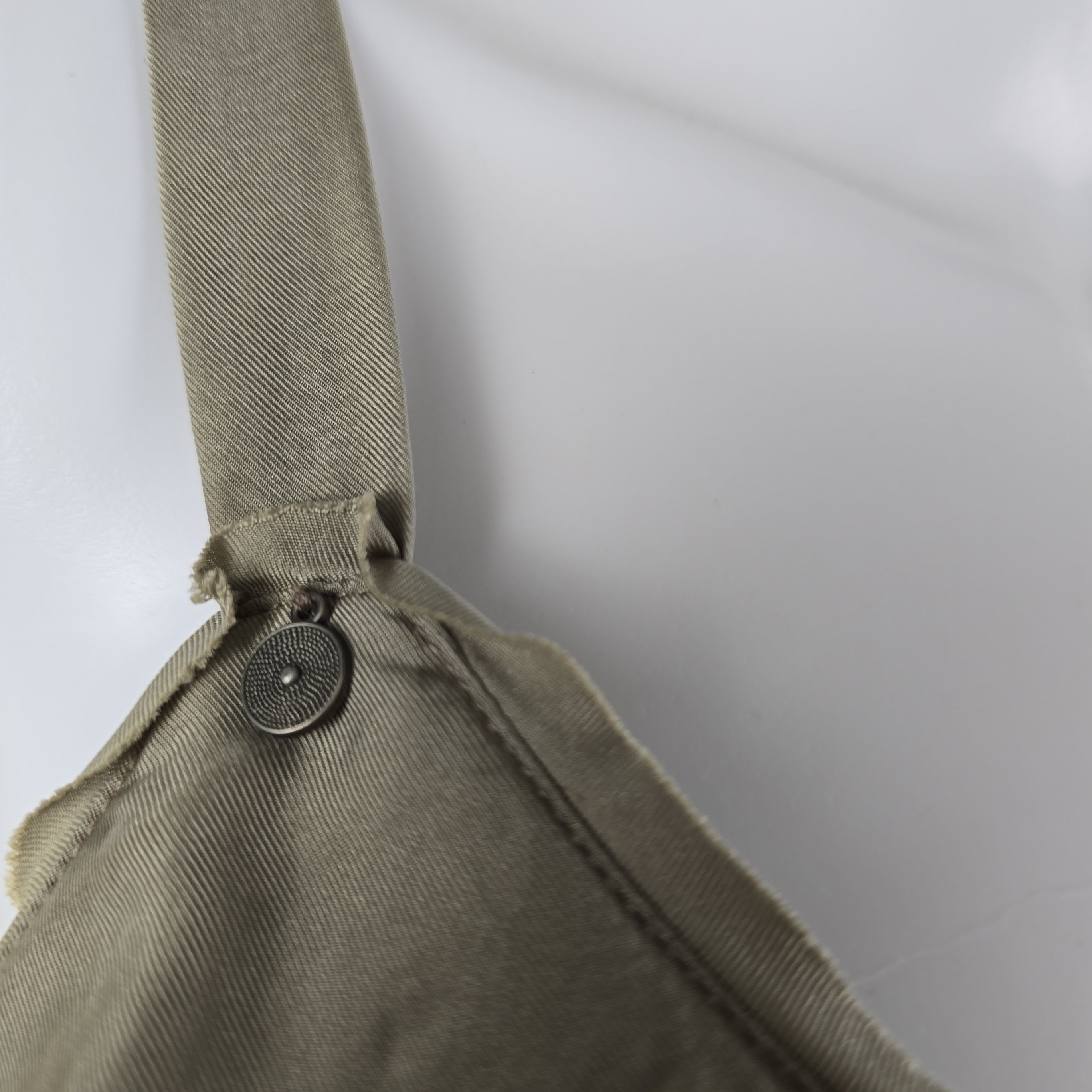 Close-up of a button on a gray fabric with a plain background