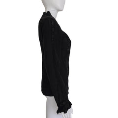 Black long sleeved button up top with black lace details on a light background