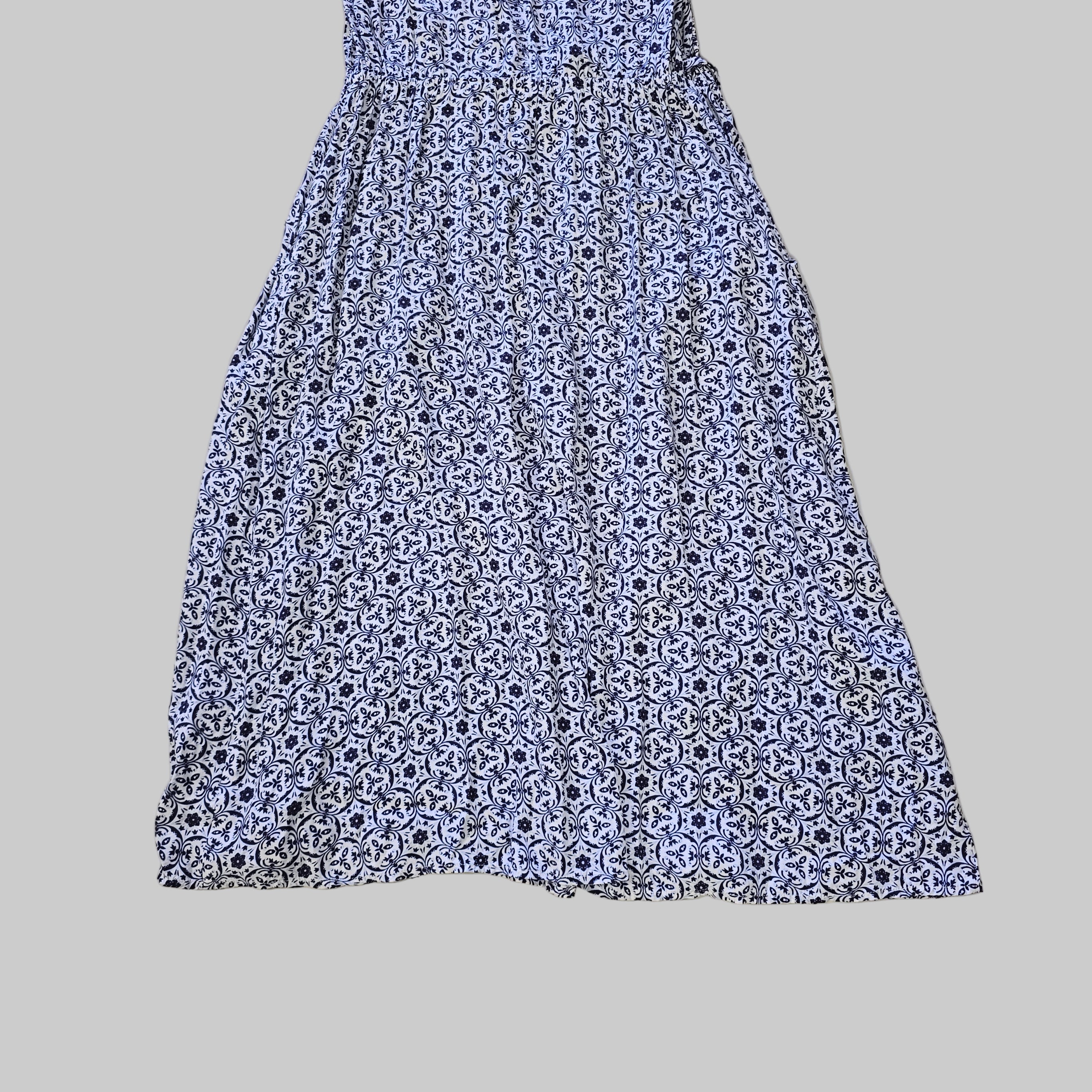 Blue and white patterned skirt on a tiled floor