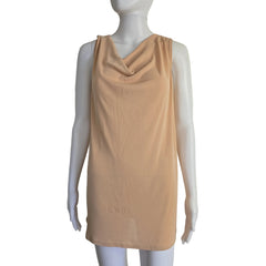Mannequin wearing a beige top on a plain background