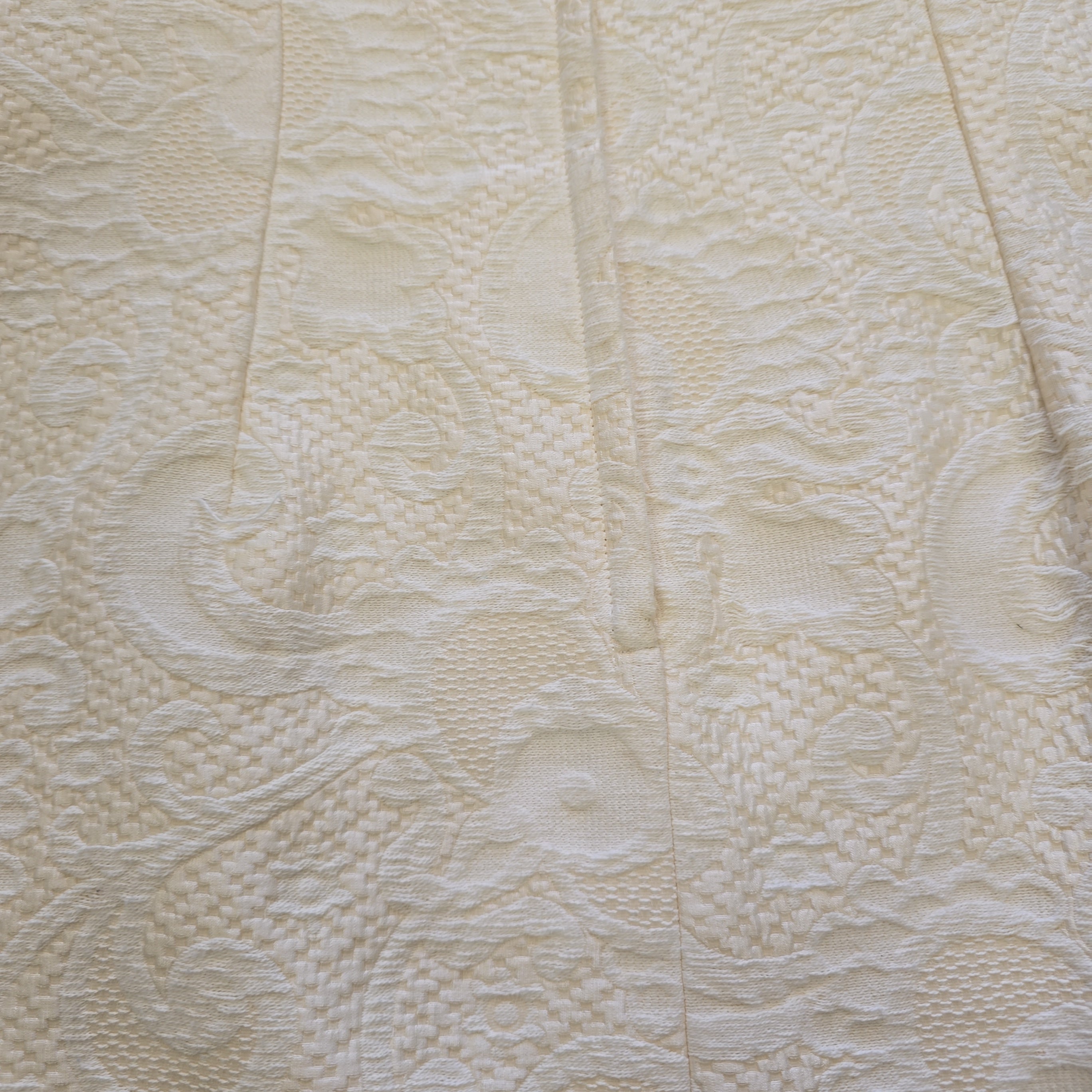 Close-up of textured beige fabric with a subtle pattern