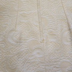Close-up of textured beige fabric with a subtle pattern
