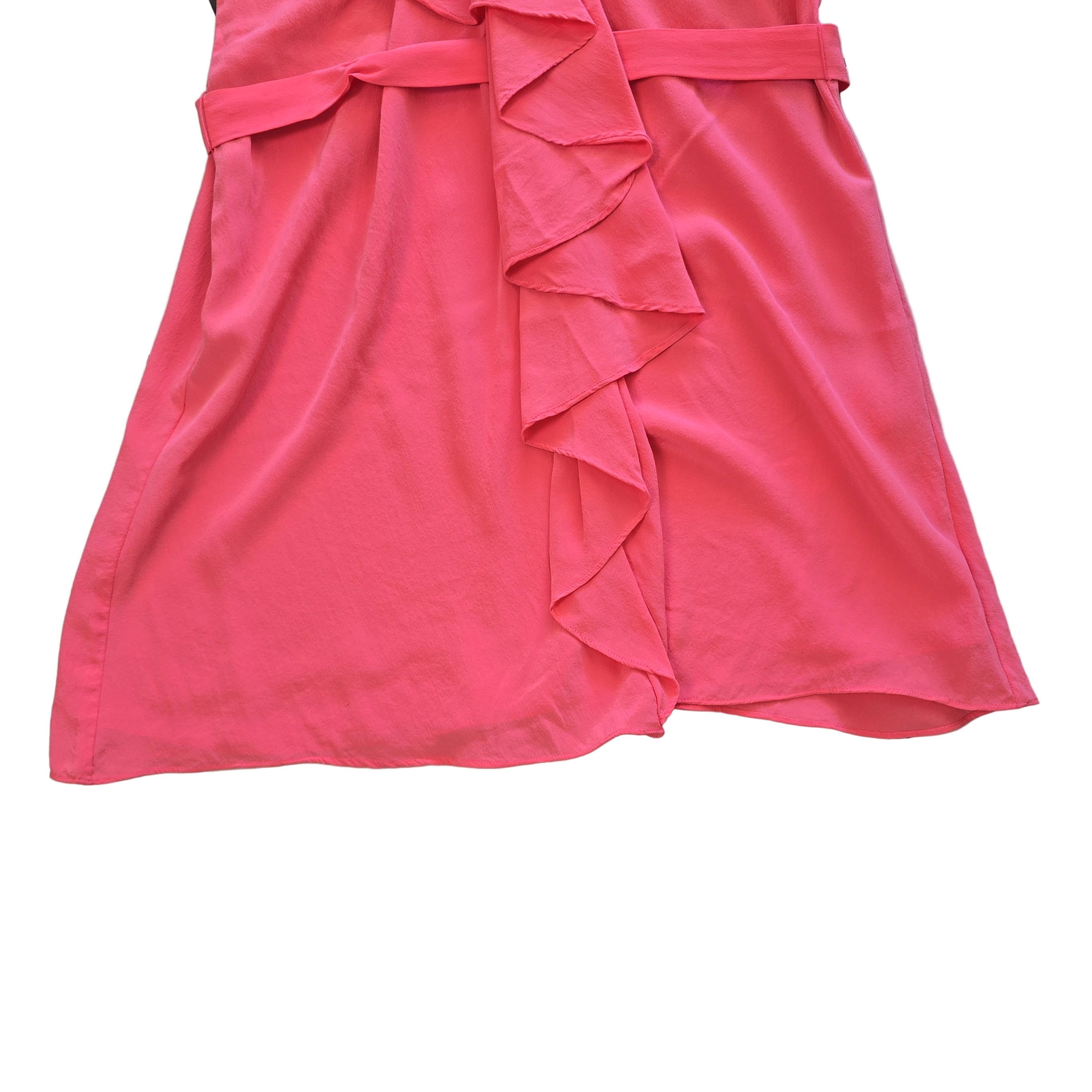 Pink dress with ruffled details on a light background