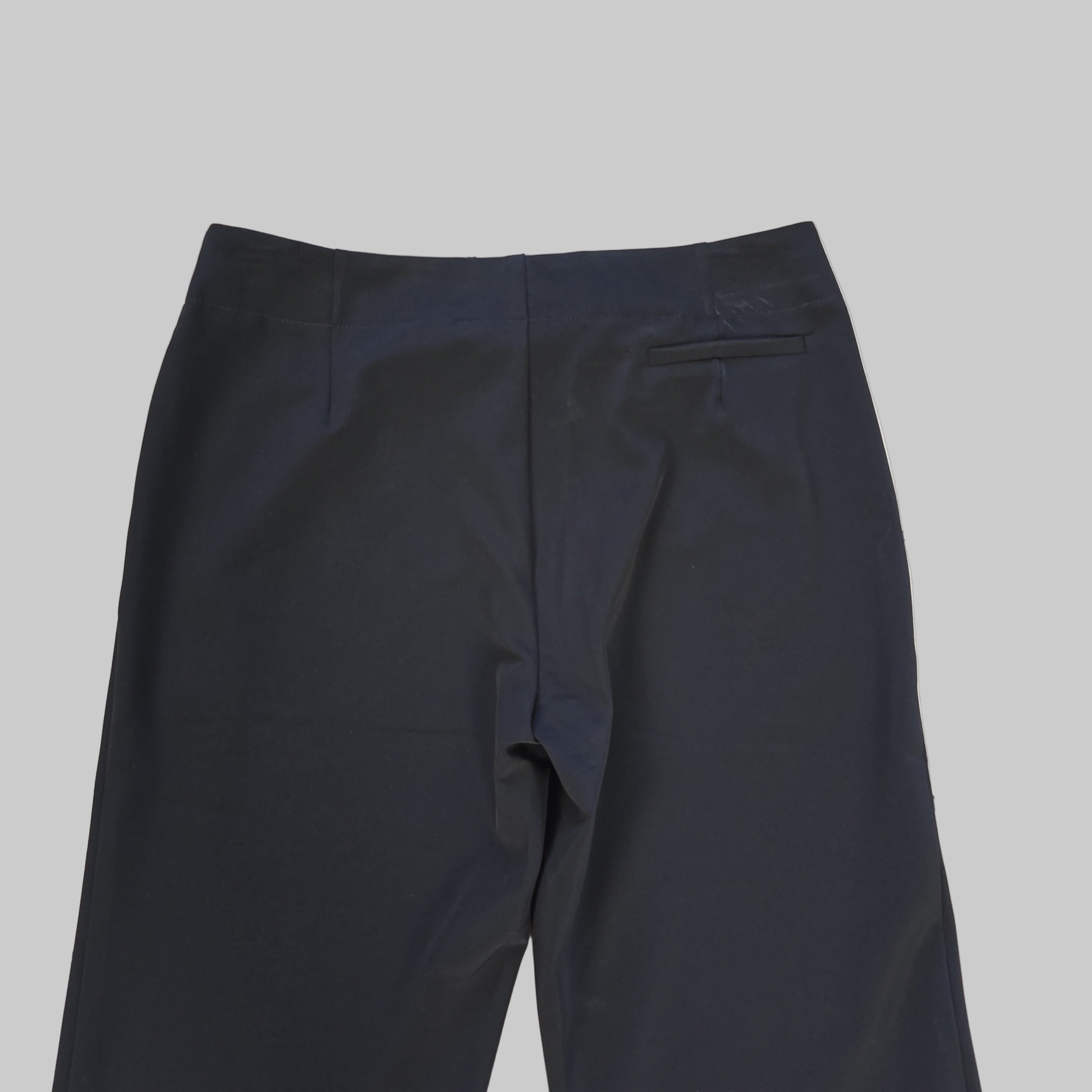 Dark blue pants on a light tiled floor