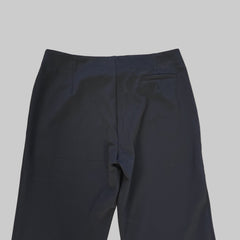 Dark blue pants on a light tiled floor