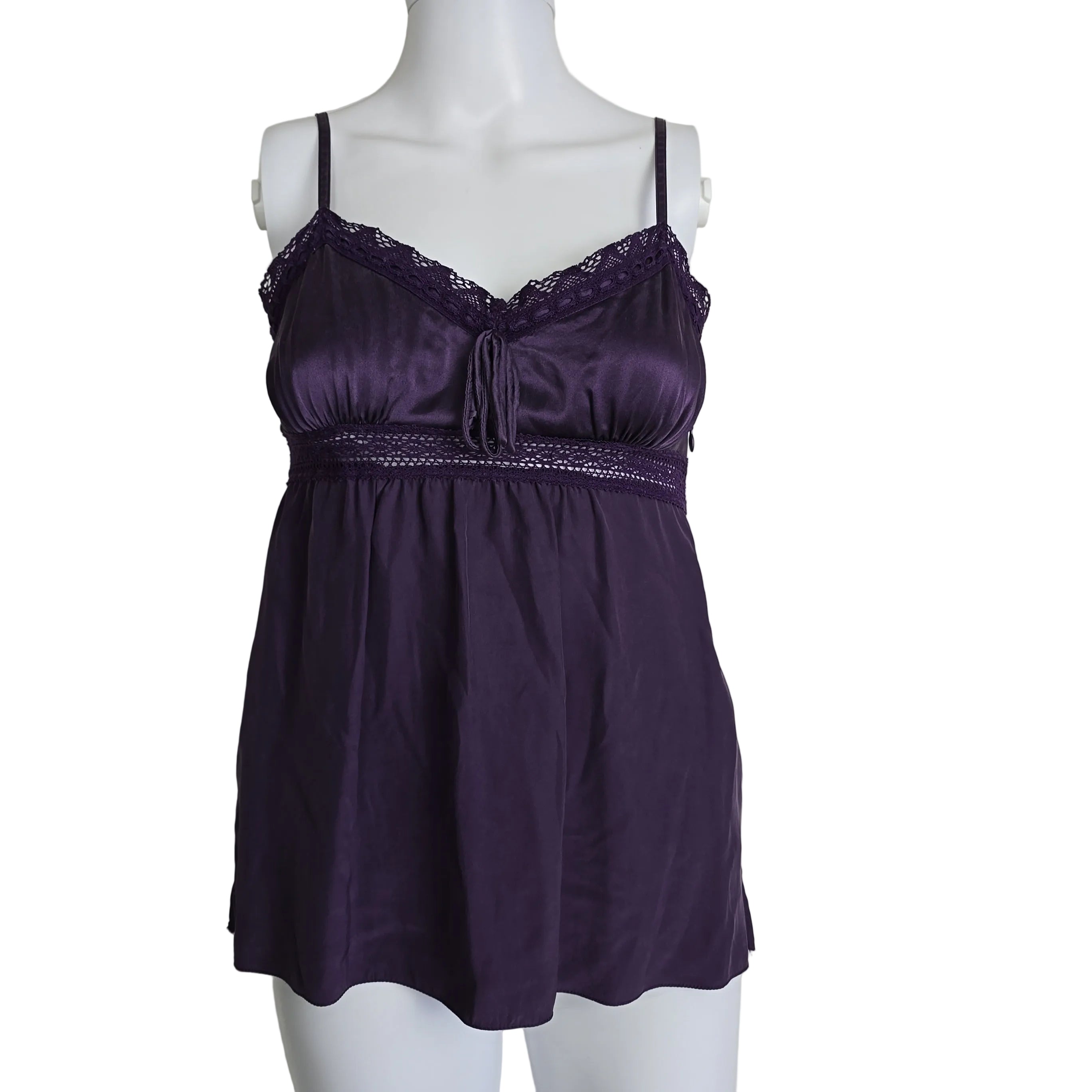Purple dress on a mannequin against a plain background