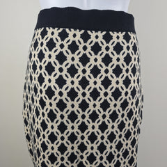 Black and cream patterned skirt on a light gray surface