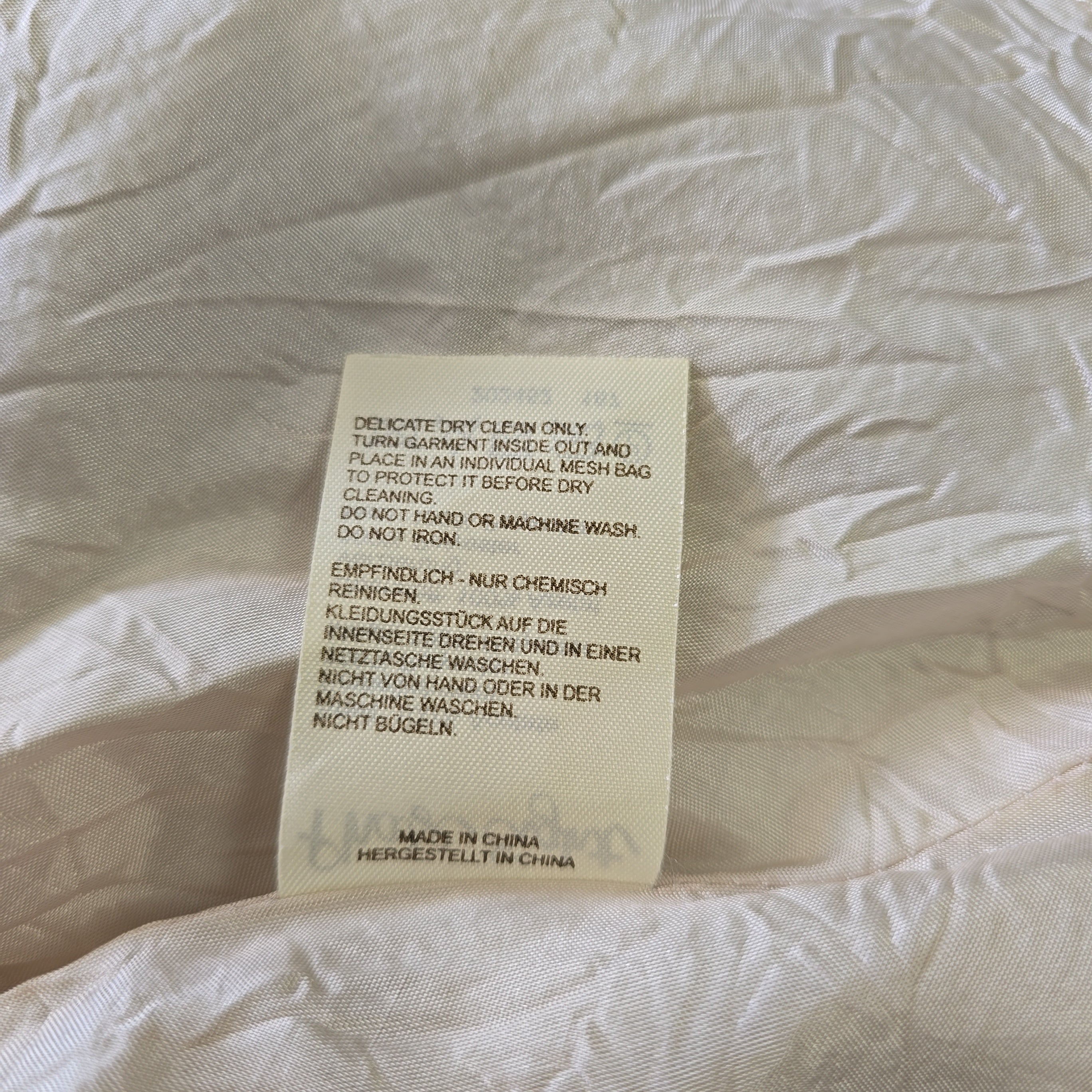 Fabric tag on a textured beige fabric background