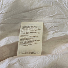 Fabric tag on a textured beige fabric background