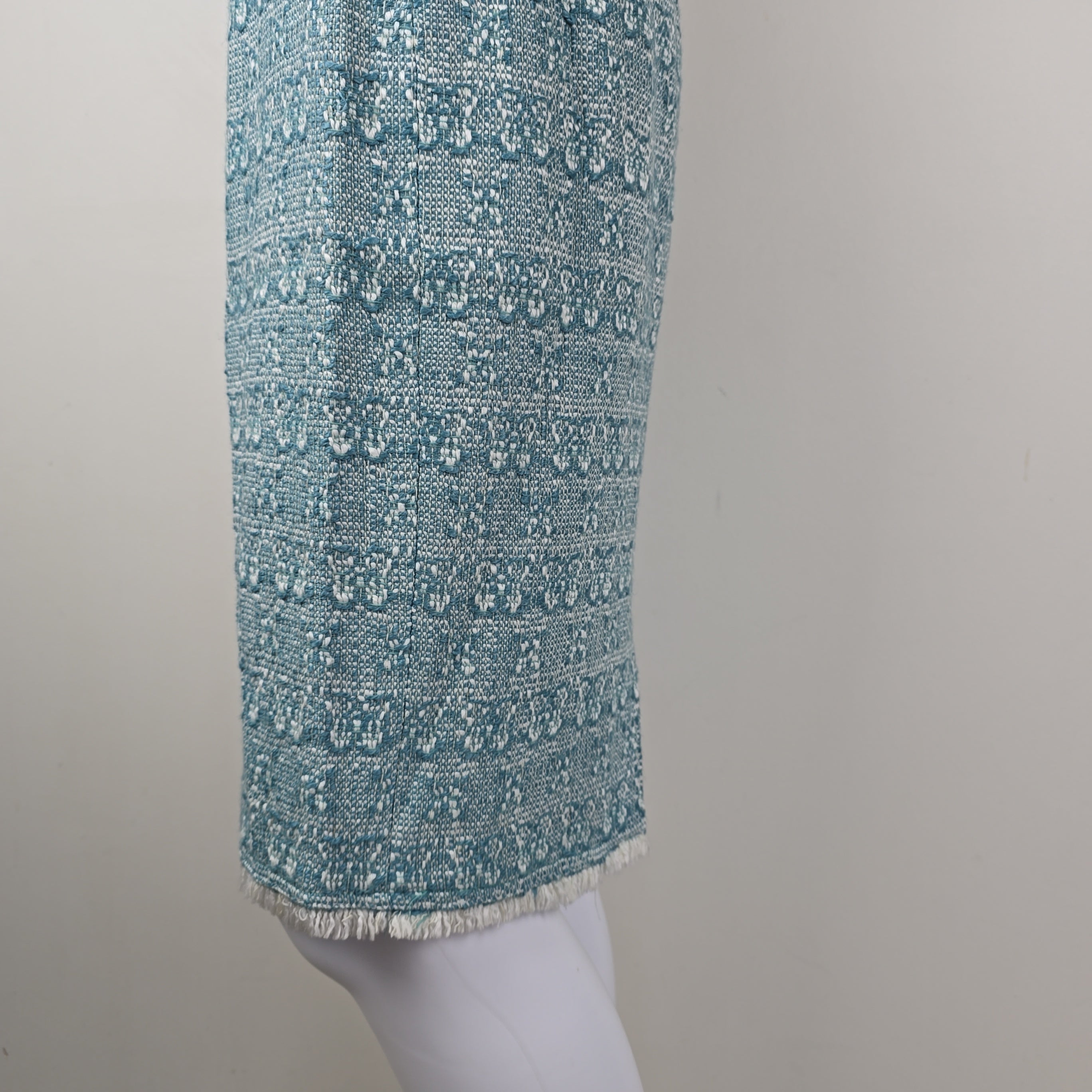 Roll of blue textured fabric on a gray background