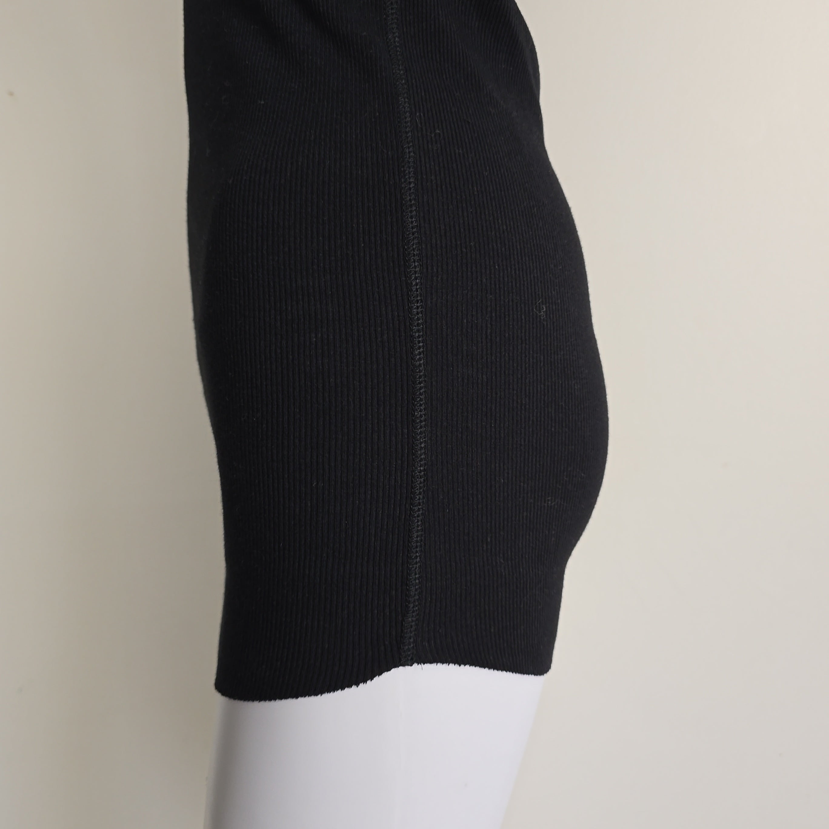 Black sleeveless top on a light background