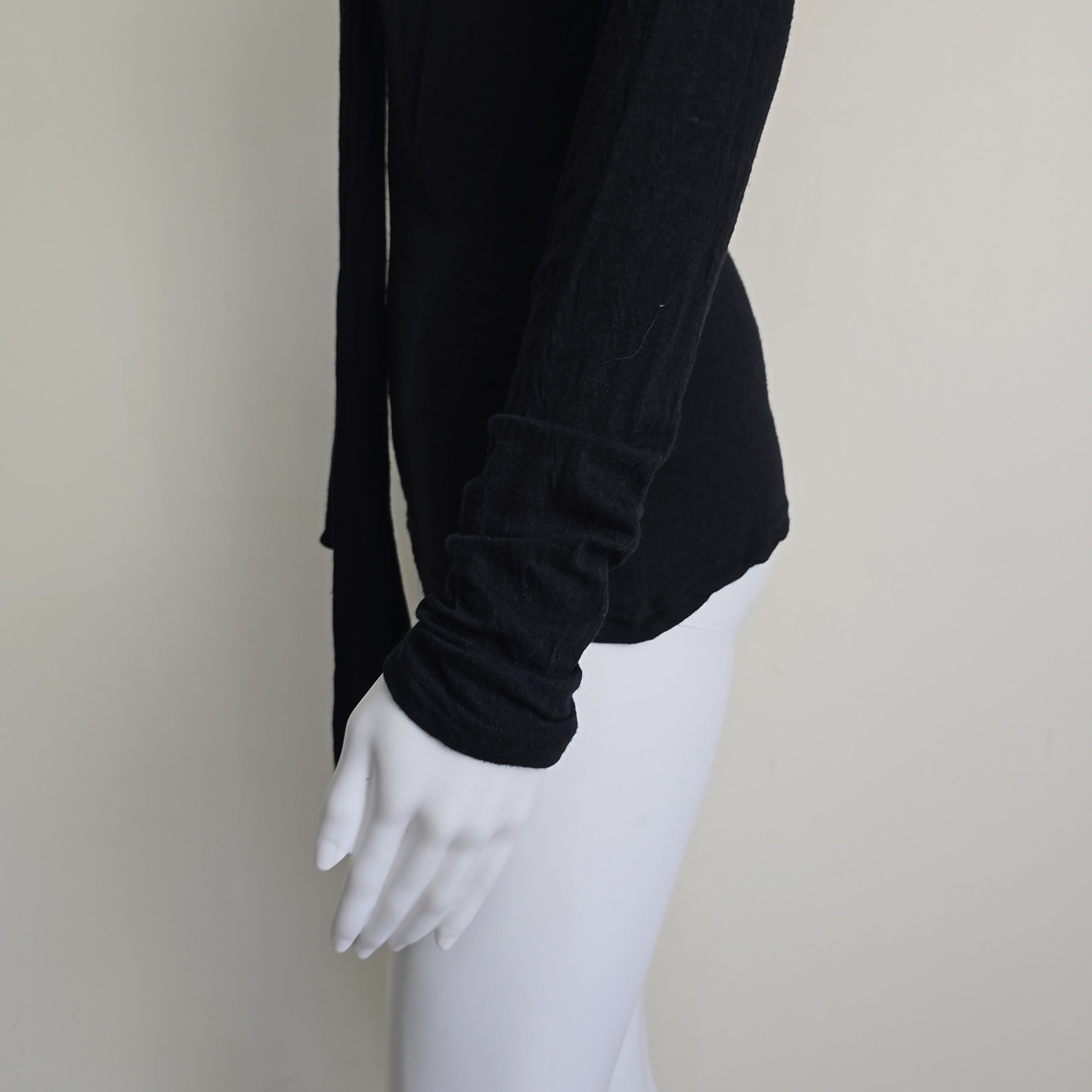 Black top with tie detail on a light background