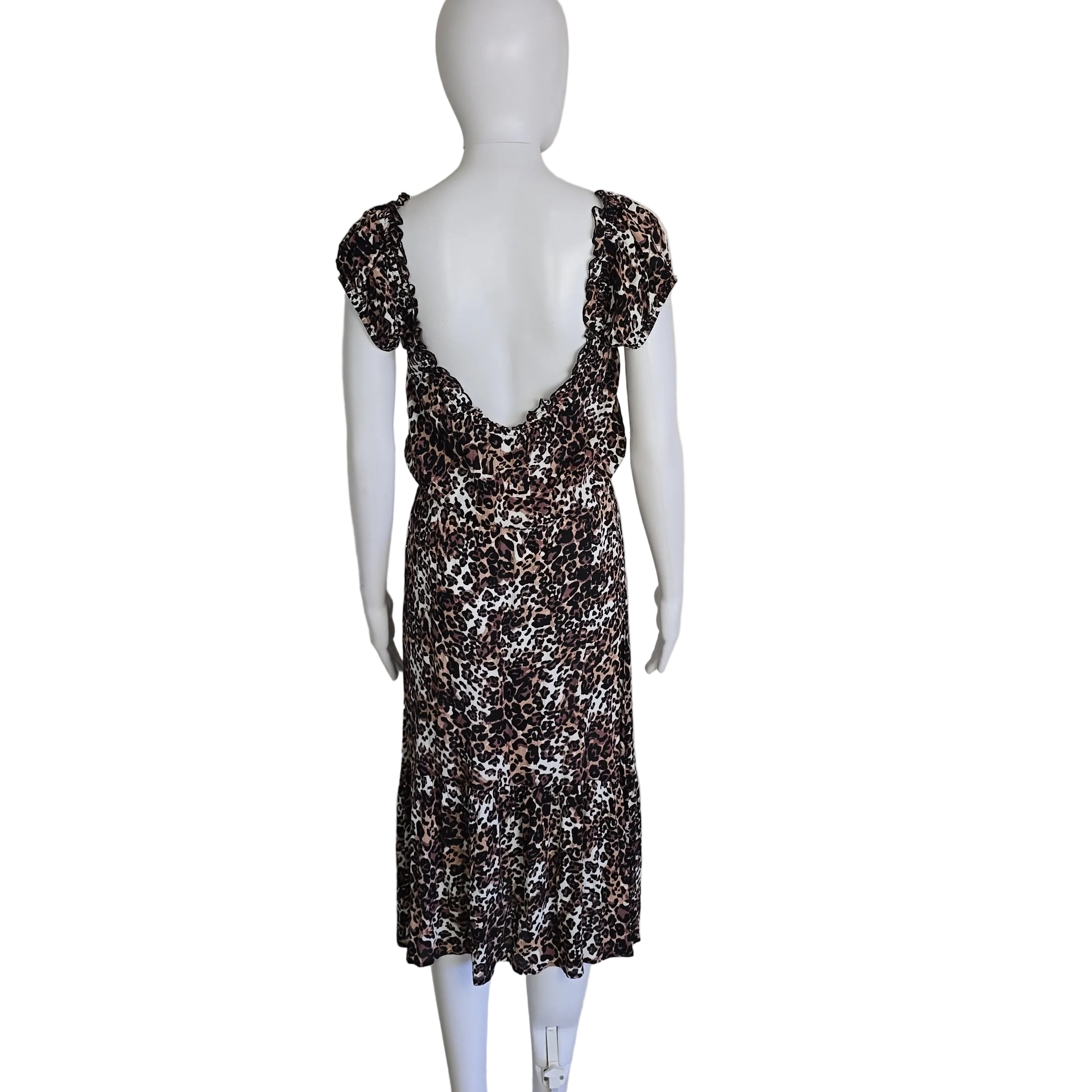 Mannequin wearing a patterned dress against a plain background