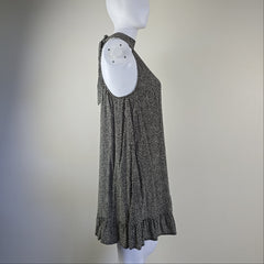 Grey and white spotted patterned dress on a light background