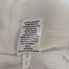 Clothing label on a white ribbed fabric background