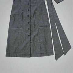 Gray striped suit jacket on a tiled floor