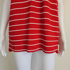 Red and white striped fabric draped over a mannequin arm against a beige background
