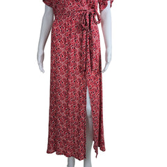 Red patterned dress on a white mannequin against a plain background