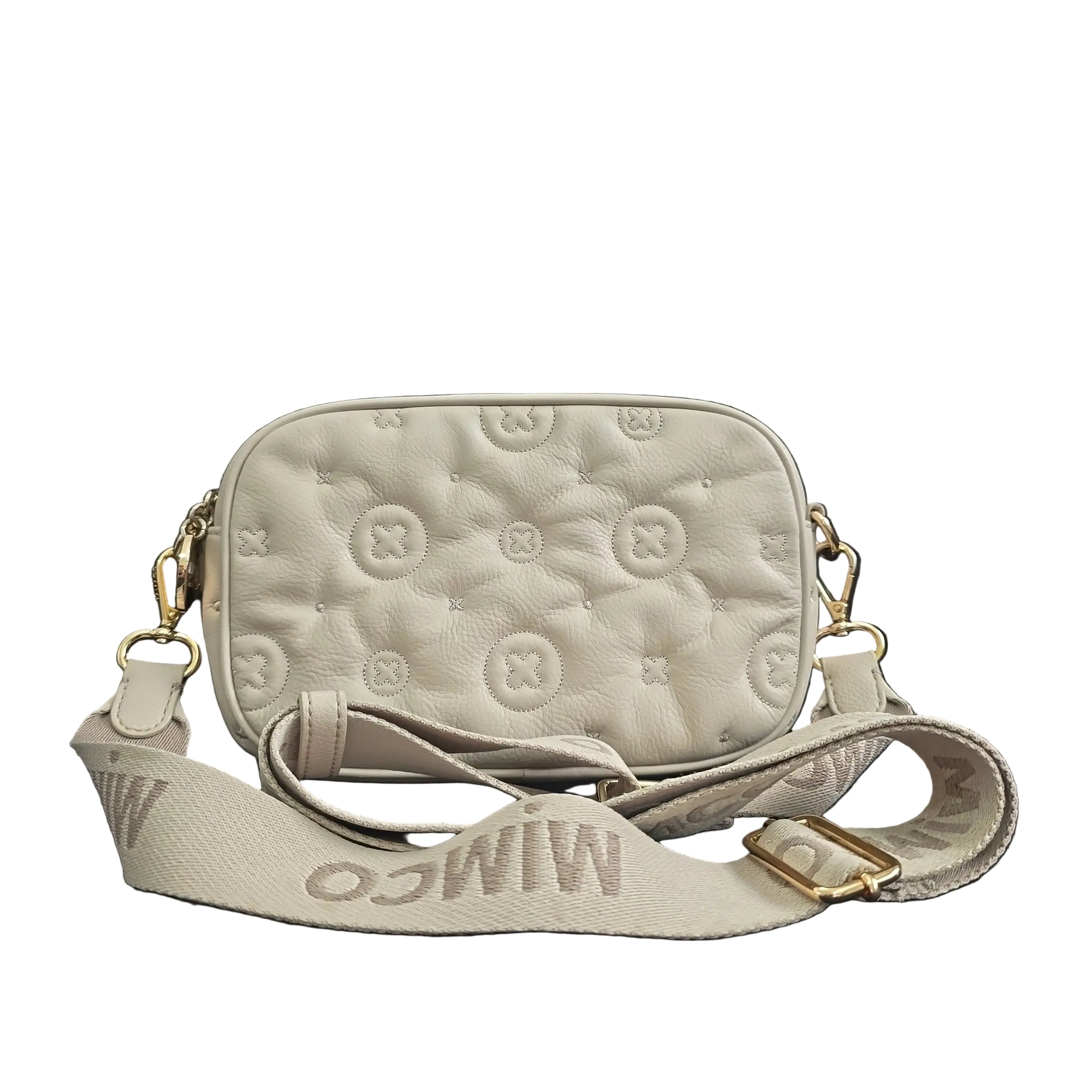 Grey shoulder bag with gold accents on a light background