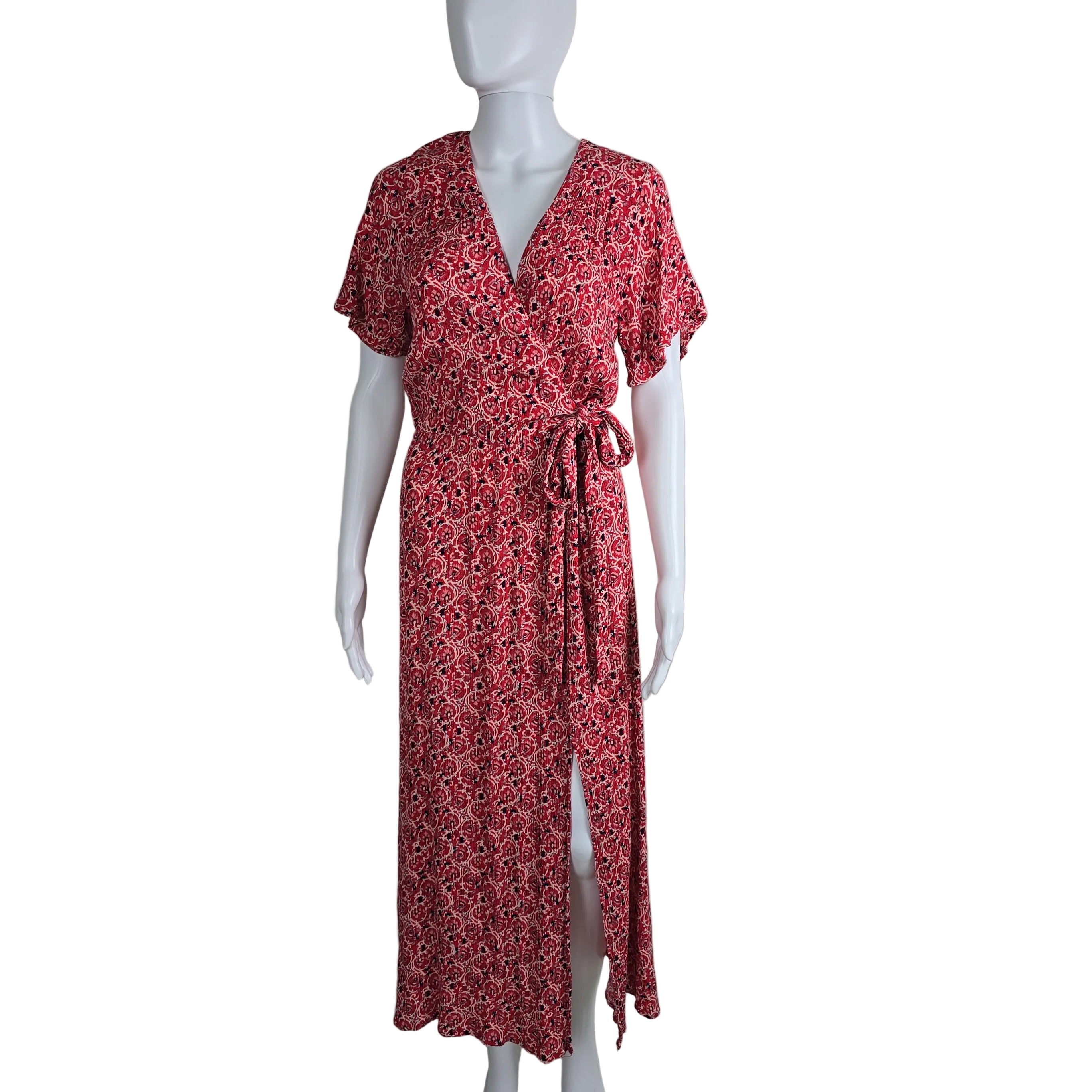 Red floral dress on a mannequin against a white wall