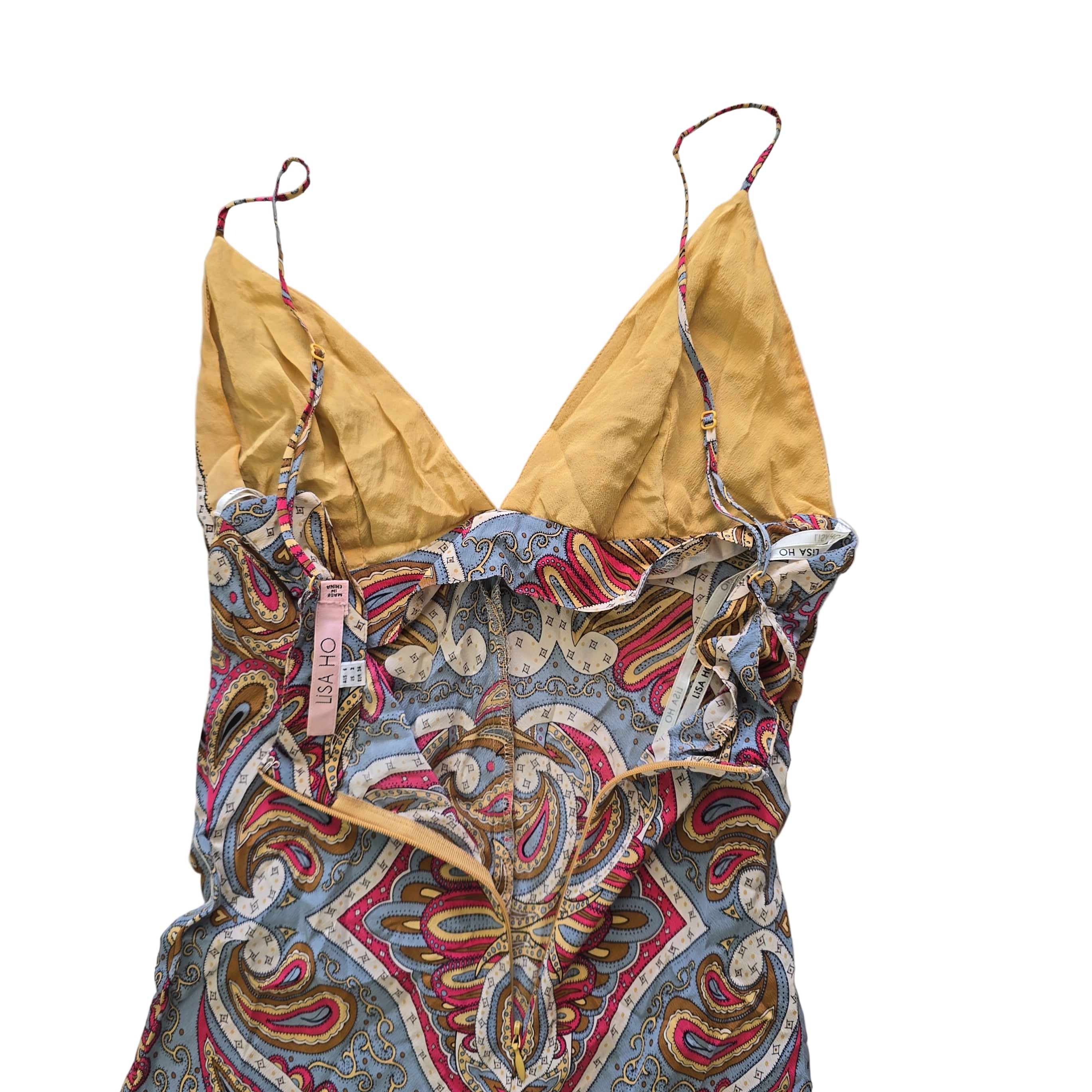 Colorful patterned dress with a yellow lining on a tiled floor