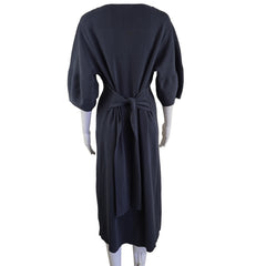 Grey dress on a white hanger against a neutral background