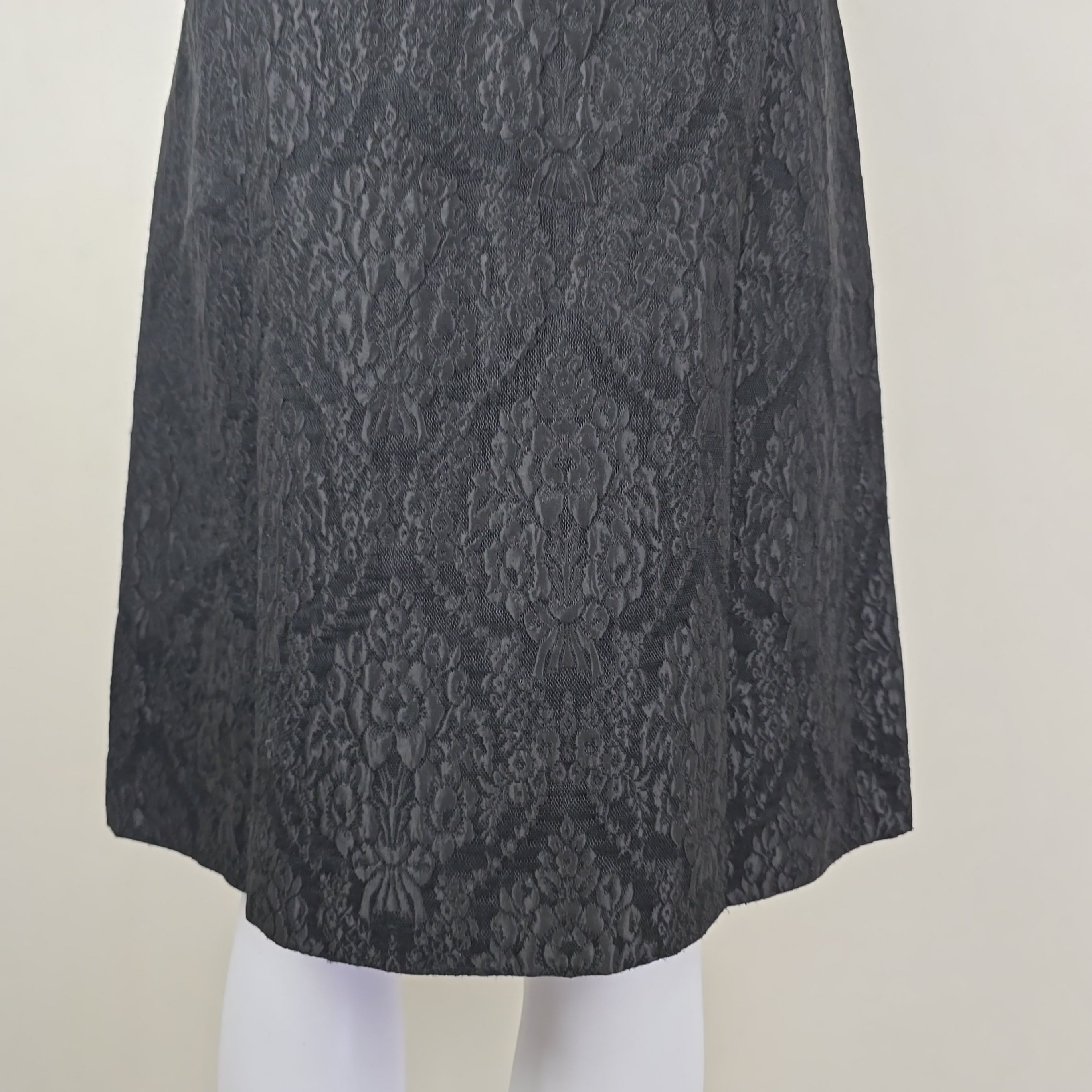 Black lace skirt on a light beige background