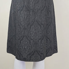 Black lace skirt on a light beige background
