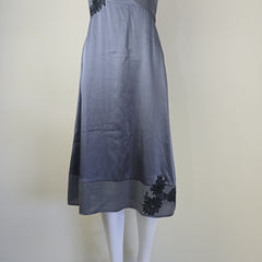 Gray skirt with black floral embroidery on a beige background