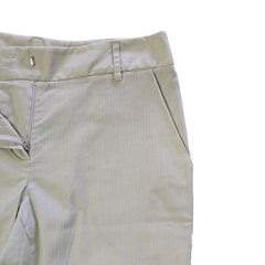 Light-colored pants on a tiled floor