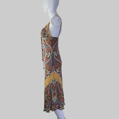 Colorful patterned garment on a mannequin against a plain background