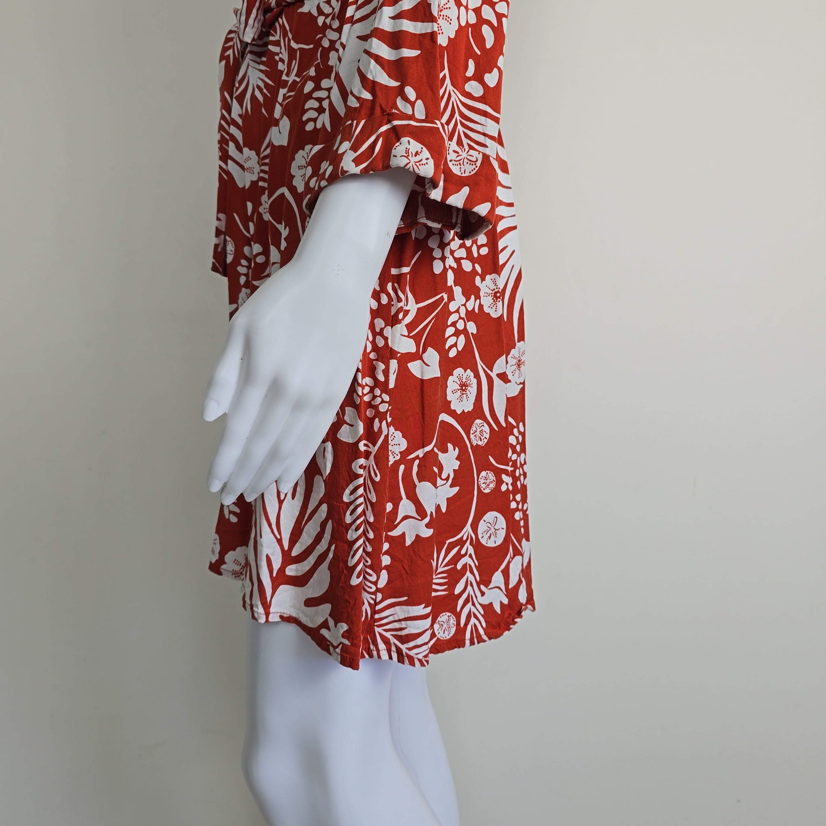 Orange and white palm patterned robe on a light background