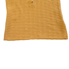 Yellow knitted tank top on a light background