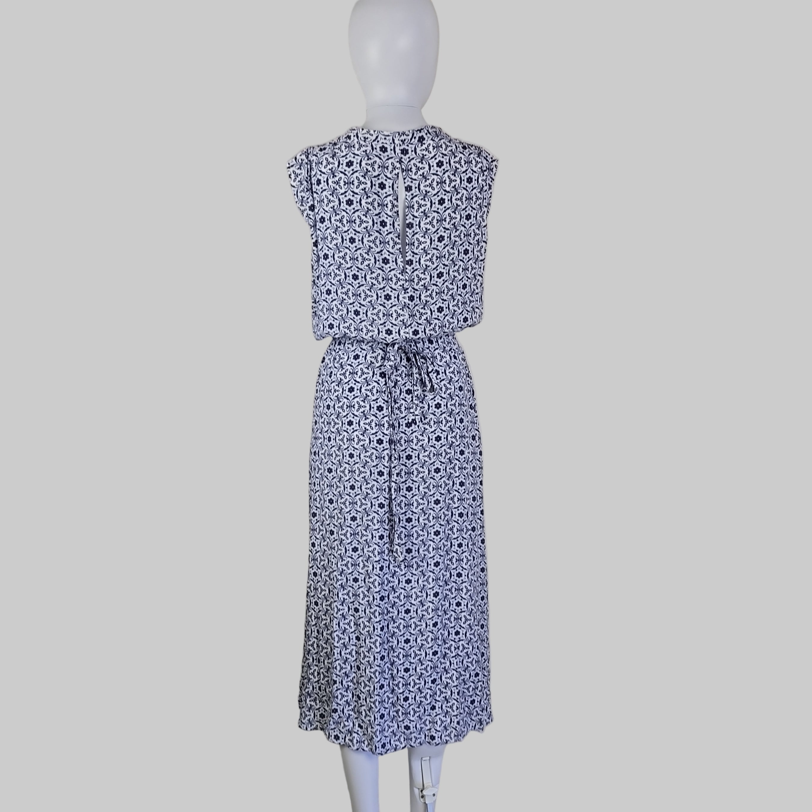 Blue floral-patterned strapless dress on a mannequin against a neutral background