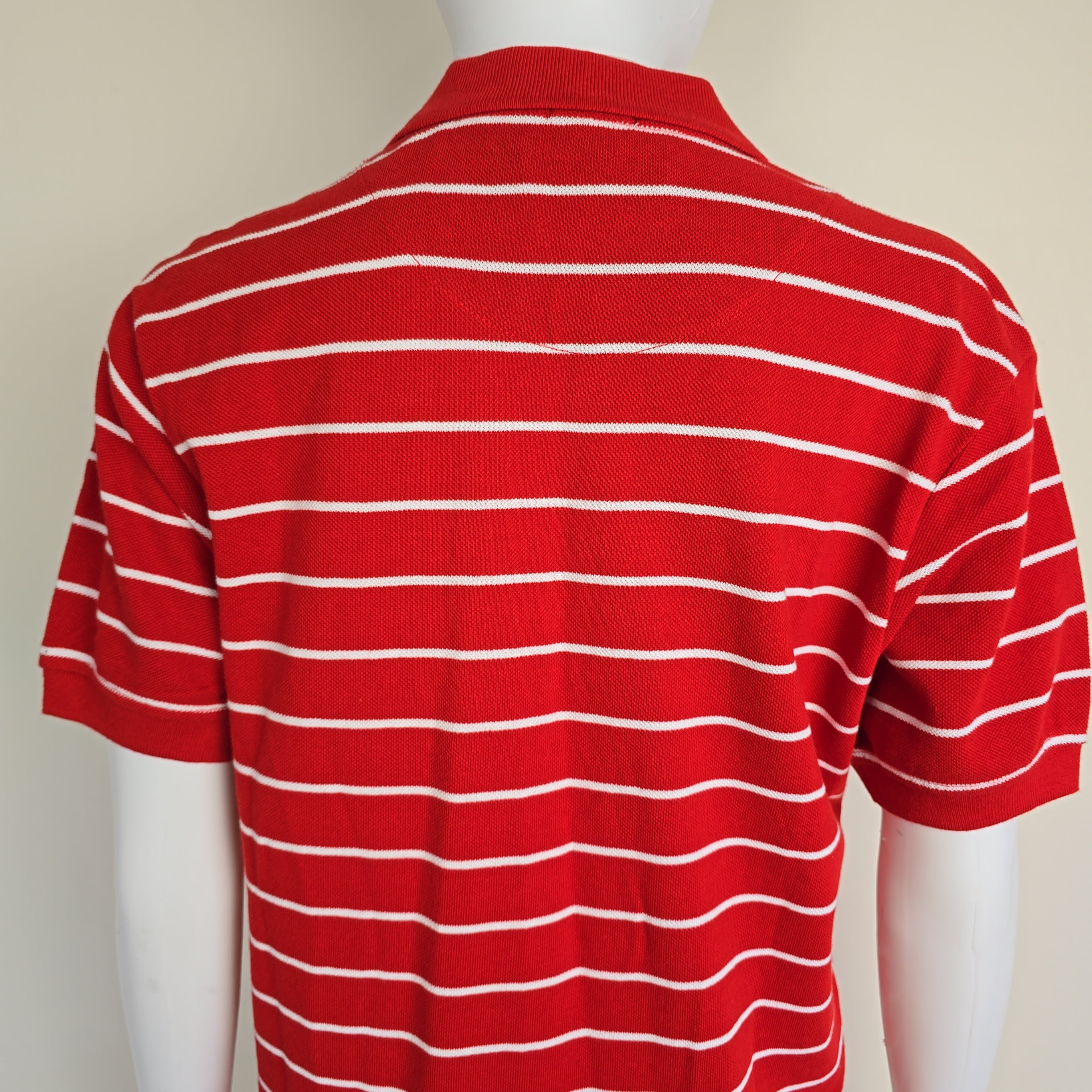 Red and white striped fabric draped over a mannequin on a beige background
