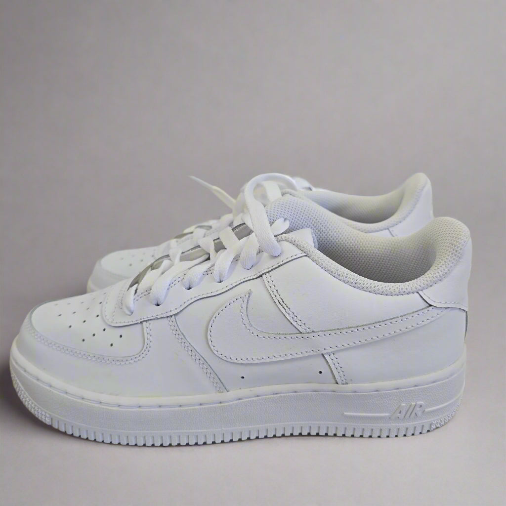 White sneaker with brand logo on a neutral background