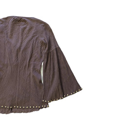 Brown textured fabric with decorative studs on a light background